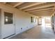 Covered patio with access to the backyard and a view of the house's exterior at 1747 W Devon --, Mesa, AZ 85201