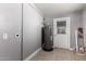 Utility room with tile flooring, water heater, and access to the exterior of the home at 1747 W Devon --, Mesa, AZ 85201