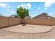 A large backyard with a brick perimeter, a block wall, and a fire pit at 1753 N St Francis Pl, Casa Grande, AZ 85122