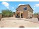 Large backyard with tan stucco home, covered patio, rock landscaping and a fire pit at 1753 N St Francis Pl, Casa Grande, AZ 85122