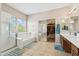 Bright bathroom with tub, walk-in shower, dual sinks, and vanity at 1753 N St Francis Pl, Casa Grande, AZ 85122