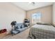 Neutral bedroom with carpet, fan, window, modular sofa, and a neatly made bed at 1753 N St Francis Pl, Casa Grande, AZ 85122