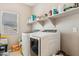 Laundry room area with washer, dryer and additional storage shelving above at 1753 N St Francis Pl, Casa Grande, AZ 85122