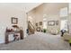 Open-concept living room with carpet flooring, neutral walls, and tall ceilings at 1753 N St Francis Pl, Casa Grande, AZ 85122