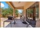Covered patio with BBQ, patio chairs, and sliding glass doors leading inside at 1753 N St Francis Pl, Casa Grande, AZ 85122