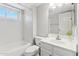 Bathroom featuring a single vanity, a large mirror, and a tub/shower with tile surround at 18819 N 49Th Ave, Glendale, AZ 85308