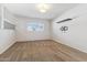 Cozy bedroom featuring neutral carpeting, a large window, and minimalist decor with ample natural light at 18819 N 49Th Ave, Glendale, AZ 85308