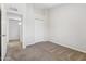 Carpeted bedroom with neutral paint, a large closet, and a glimpse into the hallway at 18819 N 49Th Ave, Glendale, AZ 85308