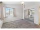 Carpeted bedroom with bright natural light, a large mirrorred closet, and neutral color scheme at 18819 N 49Th Ave, Glendale, AZ 85308