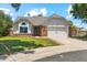 A charming single-Gathering home featuring a brick-accented facade, manicured lawn, and two-car garage at 18819 N 49Th Ave, Glendale, AZ 85308