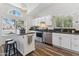 Bright kitchen featuring white cabinets, stainless steel appliances, granite countertops, and a convenient center island at 18819 N 49Th Ave, Glendale, AZ 85308