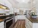 Well-lit kitchen features stainless steel appliances, granite countertops, a center island, and ample cabinet space at 18819 N 49Th Ave, Glendale, AZ 85308