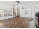Bright, open living room with vaulted ceilings, laminate flooring, a modern fireplace, and staircase access at 18819 N 49Th Ave, Glendale, AZ 85308
