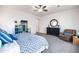 Inviting bedroom features soft carpet, ceiling fan, comfortable recliner, and modern decorations at 19598 E Walnut Rd, Queen Creek, AZ 85142