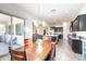 Open dining area with sliding doors to an outdoor patio and modern light fixture at 19598 E Walnut Rd, Queen Creek, AZ 85142