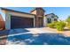 Charming home featuring a stone-accented facade, a two car garage and low maintenance desert landscaping at 19598 E Walnut Rd, Queen Creek, AZ 85142