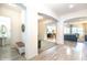 Bright hallway with tile flooring leading to a powder room and open-concept living area at 19598 E Walnut Rd, Queen Creek, AZ 85142