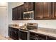 Close-up of kitchen featuring stainless steel appliances and granite countertops at 19598 E Walnut Rd, Queen Creek, AZ 85142