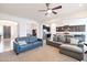 Open-concept living area with a ceiling fan and seamless flow into the kitchen at 19598 E Walnut Rd, Queen Creek, AZ 85142