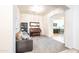 Comfortable living room featuring a piano, sofa, and open access to the modern kitchen at 19598 E Walnut Rd, Queen Creek, AZ 85142
