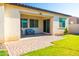 Covered patio with a bench, offering an inviting outdoor space and lush green lawn at 19598 E Walnut Rd, Queen Creek, AZ 85142
