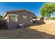 The backyard features desert landscaping and stucco walls for privacy at 20919 E Desert Hills Blvd, Queen Creek, AZ 85142