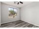 Bedroom with a large window offering neighborhood views and gray vinyl floors at 20919 E Desert Hills Blvd, Queen Creek, AZ 85142