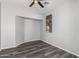 Modern bedroom with gray walls, a window nook, vinyl floors and a ceiling fan at 20919 E Desert Hills Blvd, Queen Creek, AZ 85142