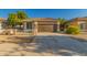 Charming single-story home featuring a tile roof, brown garage door, and low-maintenance landscaping at 20919 E Desert Hills Blvd, Queen Creek, AZ 85142
