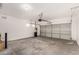 Bright garage featuring a garage door, epoxy floors, and a water softener at 20919 E Desert Hills Blvd, Queen Creek, AZ 85142