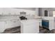 Beautiful kitchen with white cabinets, a center island, subway tile backsplash, and gray wood floors at 20919 E Desert Hills Blvd, Queen Creek, AZ 85142