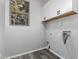 Laundry room featuring gray vinyl floors, white cabinets, and a window at 20919 E Desert Hills Blvd, Queen Creek, AZ 85142