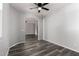 Bright living room featuring modern gray walls, vinyl floors, and an arched doorway at 20919 E Desert Hills Blvd, Queen Creek, AZ 85142