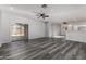 Spacious living room featuring modern gray wood floors and lots of natural light at 20919 E Desert Hills Blvd, Queen Creek, AZ 85142