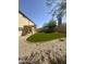 Backyard with a covered patio, artificial grass, and gravel at 2114 N 94Th Ave, Phoenix, AZ 85037