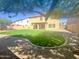 Expansive backyard showcasing artificial turf, block fencing, and a covered patio, perfect for entertaining and relaxing outdoors at 2114 N 94Th Ave, Phoenix, AZ 85037