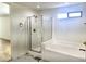 Bathroom featuring separate shower and tub with marble tile flooring at 2114 N 94Th Ave, Phoenix, AZ 85037