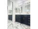 Bathroom with dual vanities, gold fixtures, and marble flooring at 2114 N 94Th Ave, Phoenix, AZ 85037