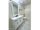 Bathroom featuring a modern vanity with black hardware and tiled shower at 2114 N 94Th Ave, Phoenix, AZ 85037