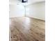 Bright bedroom featuring hardwood flooring and a modern ceiling fan at 2114 N 94Th Ave, Phoenix, AZ 85037