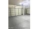 A garage with epoxy flooring and lighting at 2114 N 94Th Ave, Phoenix, AZ 85037