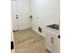 Laundry room featuring a utility sink, connections, and hardwood floor at 2114 N 94Th Ave, Phoenix, AZ 85037