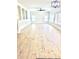 Spacious living room with light wood flooring, recessed lights, and multiple windows at 2114 N 94Th Ave, Phoenix, AZ 85037