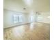 Large living room with bright natural light, wood floors, and a ceiling fan at 2114 N 94Th Ave, Phoenix, AZ 85037