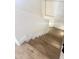 Wooden staircase with white walls and handrail at 2114 N 94Th Ave, Phoenix, AZ 85037