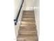 A staircase featuring hardwood steps and white trim at 2114 N 94Th Ave, Phoenix, AZ 85037