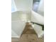 Wooden staircase with white walls and a dark handrail at 2114 N 94Th Ave, Phoenix, AZ 85037