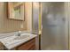 En suite bathroom with a single sink vanity and shower with glass doors at 2138 W Northview Ave, Phoenix, AZ 85021