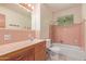 Pink bathroom with a sink, vanity, commode and a tub with shower at 2138 W Northview Ave, Phoenix, AZ 85021