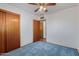 Carpeted bedroom with a ceiling fan and closet at 2138 W Northview Ave, Phoenix, AZ 85021